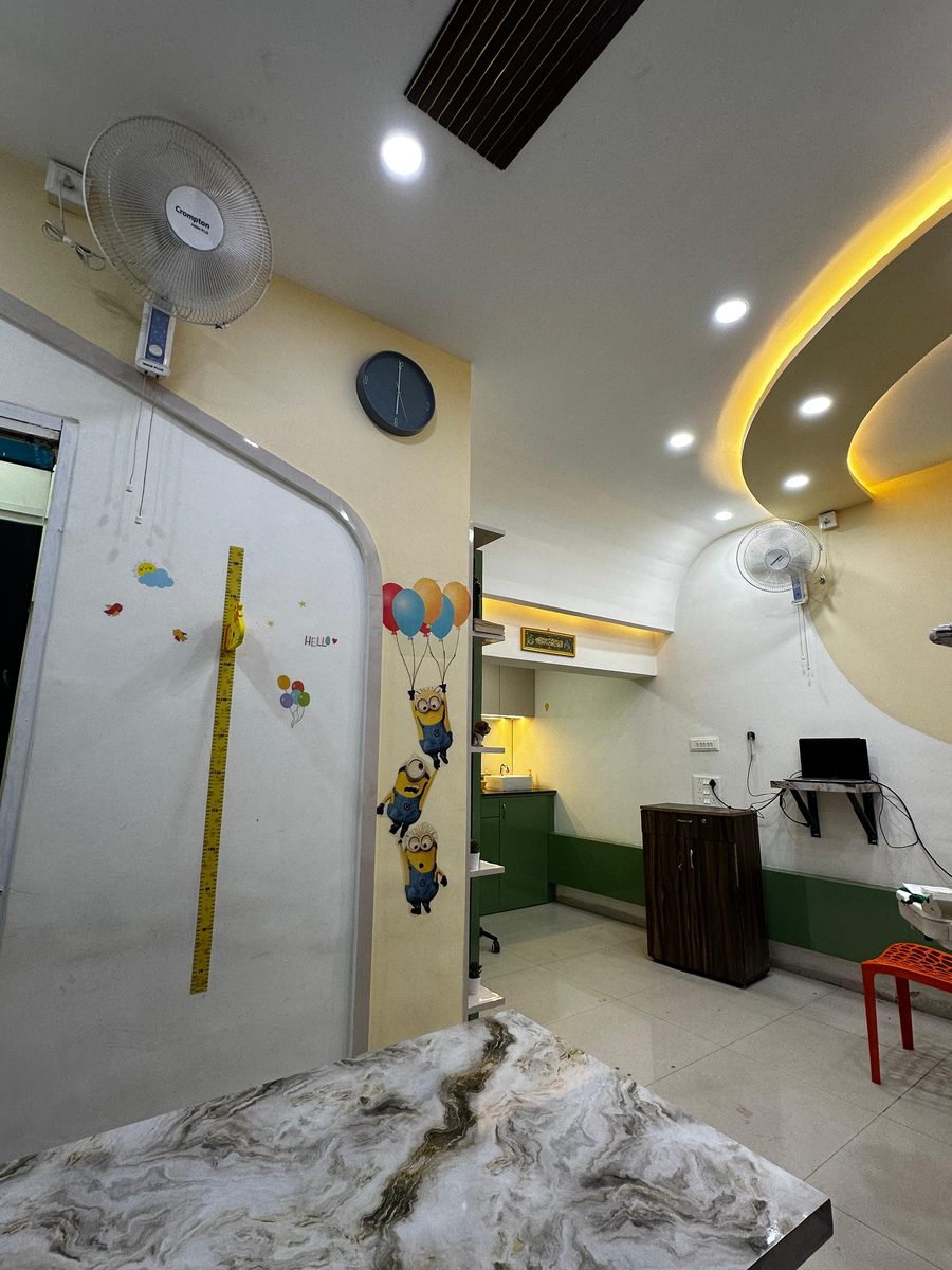 Modern dental operatory with a curved designer ceiling at Happy Tooth, Mohamadwadi, Pune