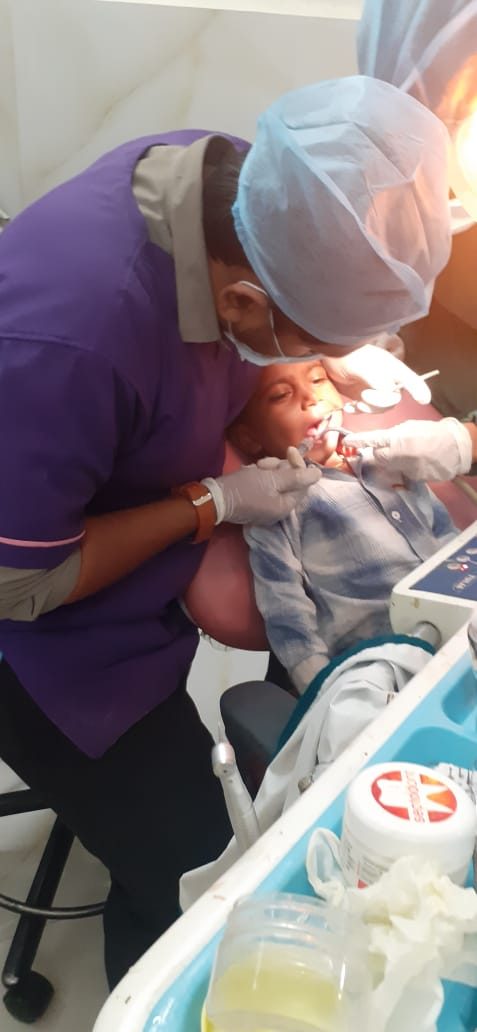 Child receiving painless dental treatment in the dental chair at Happy Tooth pediatric clinic, Pune