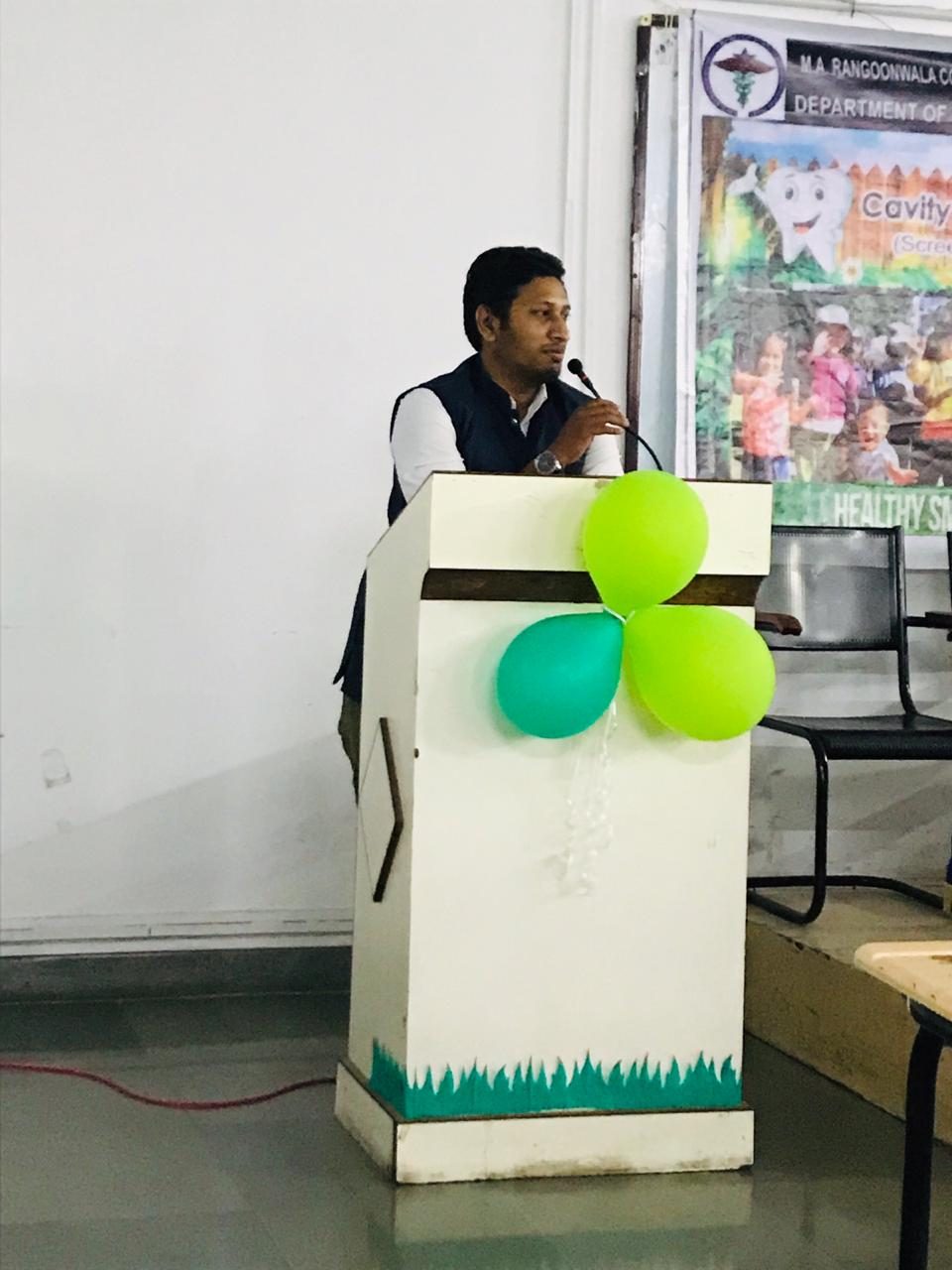 Dr. Rajat Shaikh speaking at a dental awareness and oral-health education event in Pune